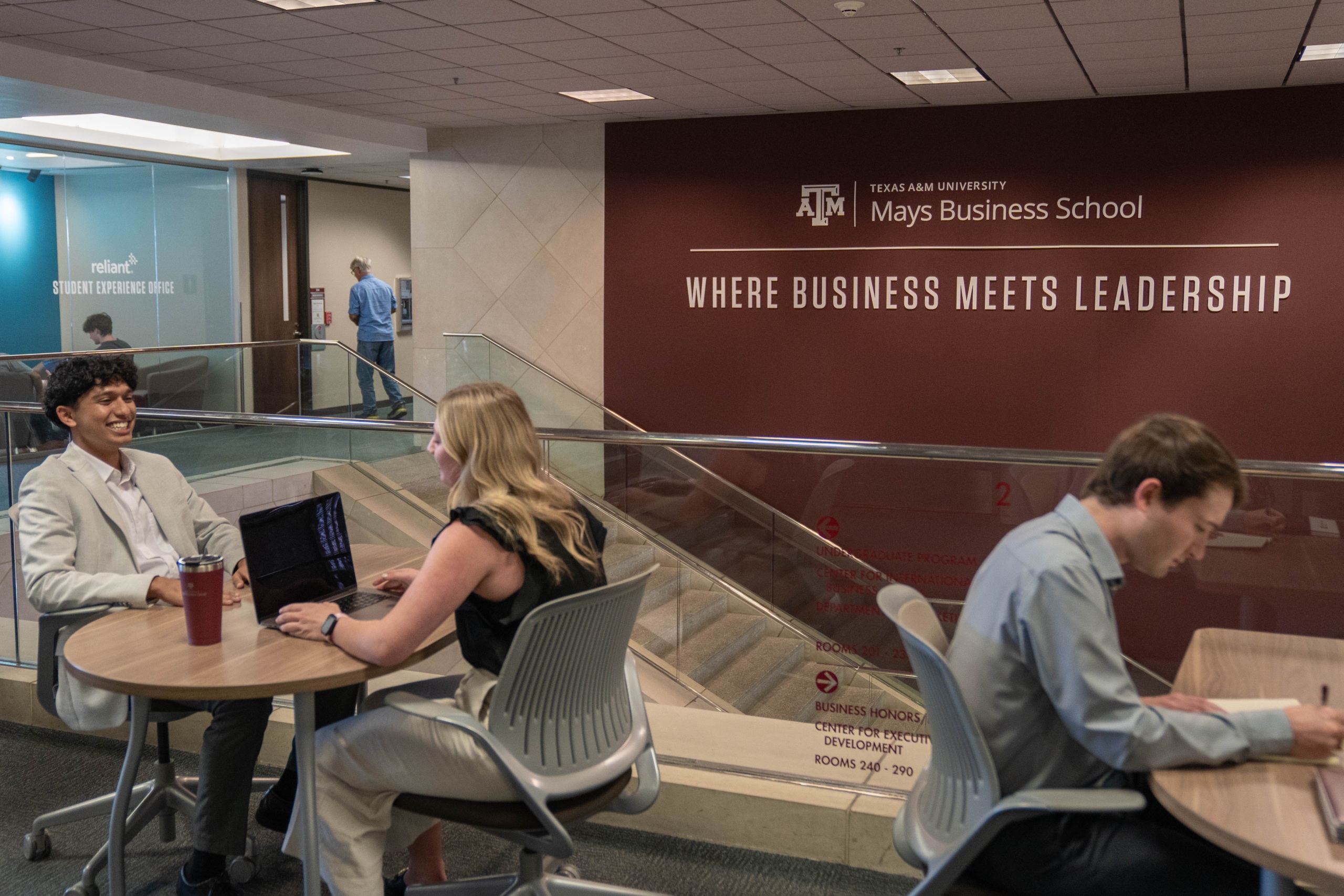 Students work at desks at Mays Business School