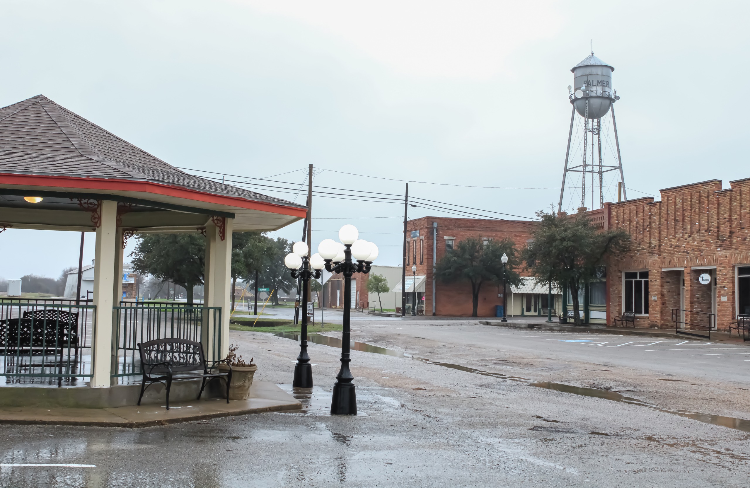 A photo of a street in Palmer, Texas, with a gazebo and a water tower.