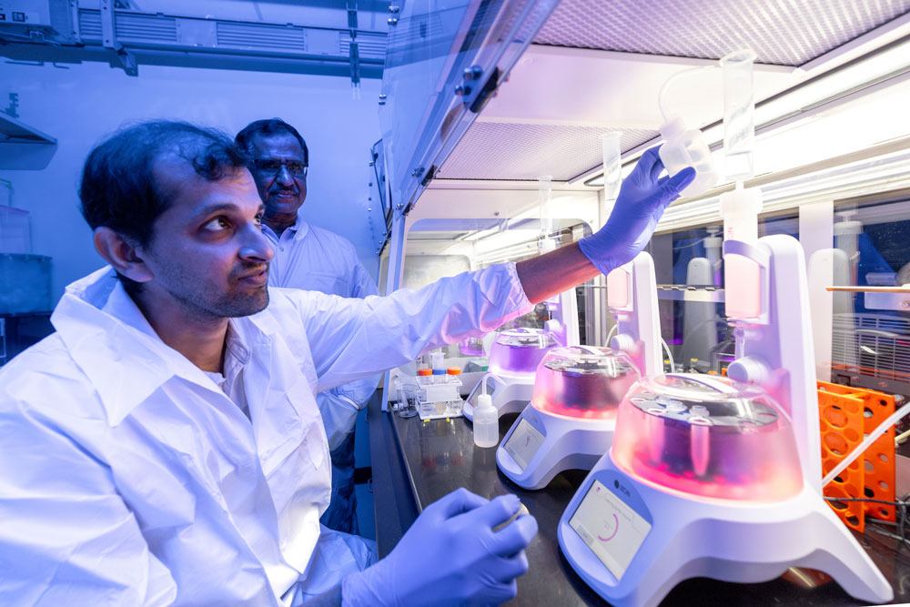 Scientist setting up centrifuge for experiment