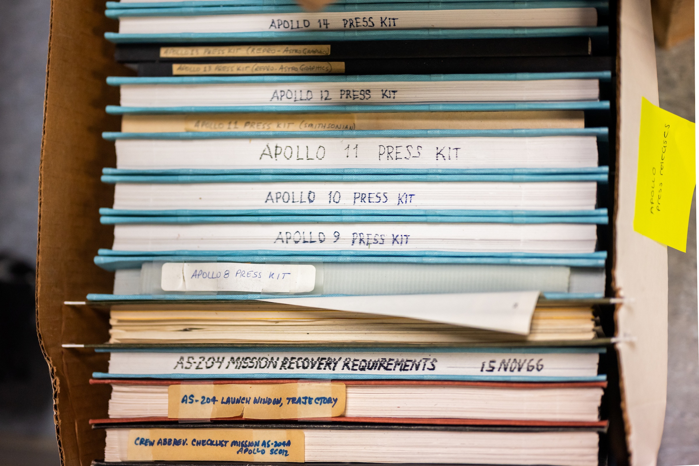 An overhead view of books stacked in a box
