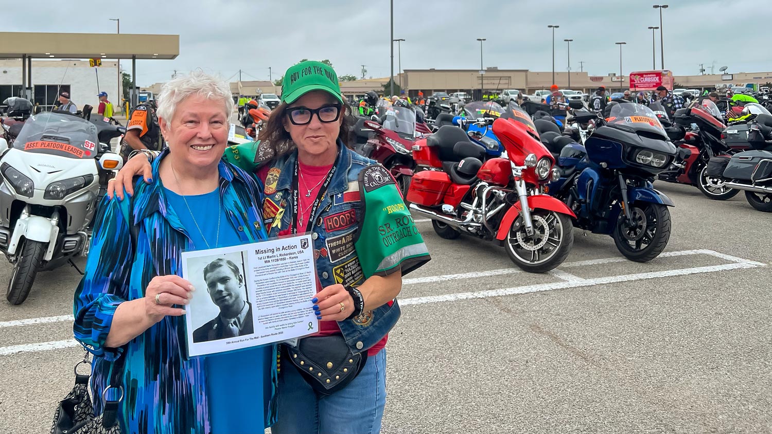 Karoni Forrester poses with a fellow MIA daughter in a parking lot in front of motorcycles