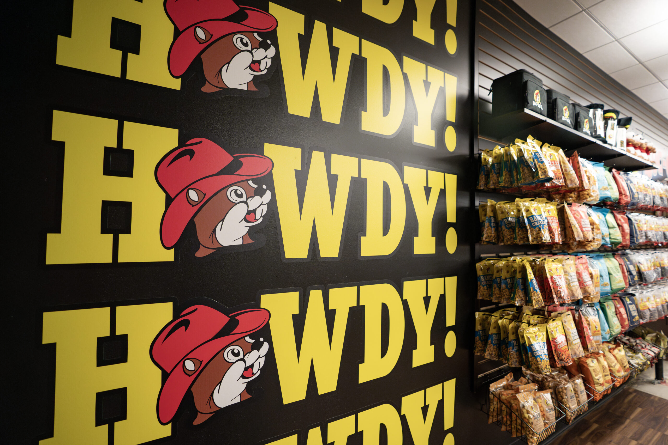 Buc-ees store shelf with HOWDY written on the wall