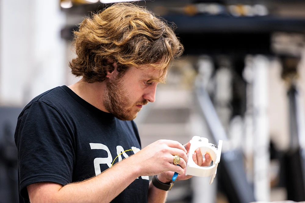 A RAD Lab student examines a 3D printed object