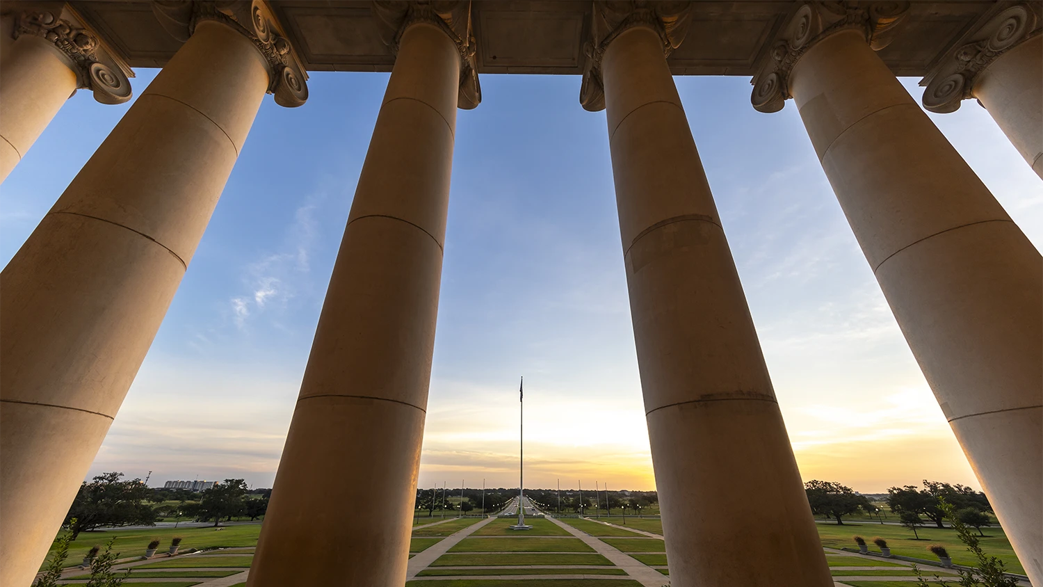 View of the Texas A&M University front lawn through the pillars on the Academic Building