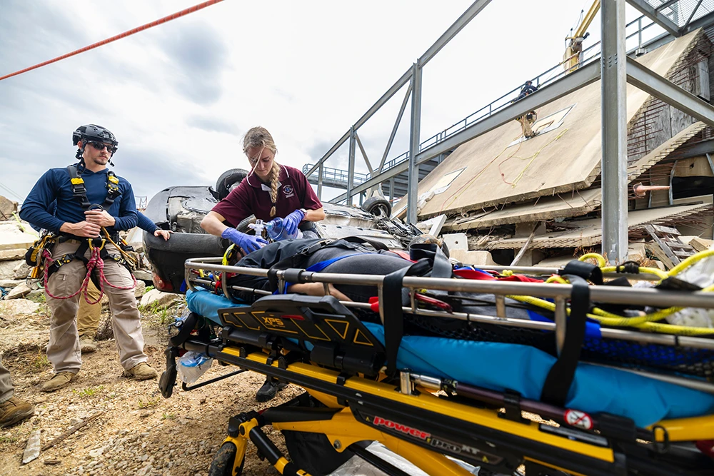 Task Force 1 and Aggie Nursing students working together at Disaster City