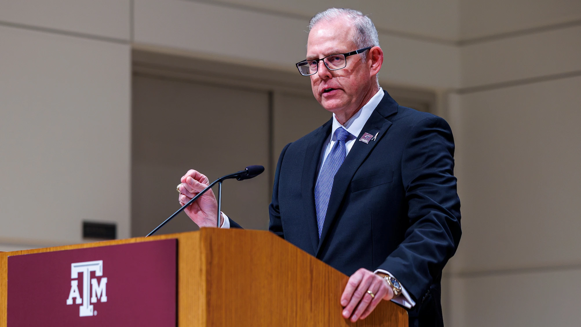 John Sherman ’92, dean of The Bush School, speaks at a podium