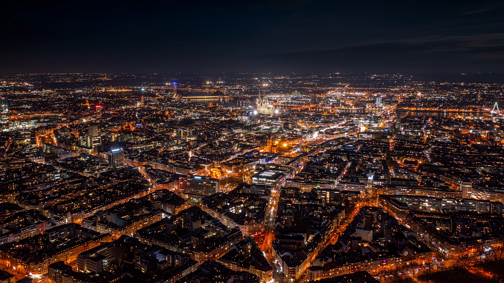 An aerial view of a city lit up at night