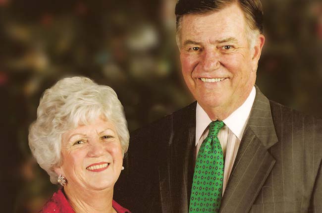 Man and woman dressed fancy pose together for portrait