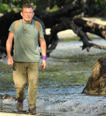 Fossum walking next to body of water in wilderness