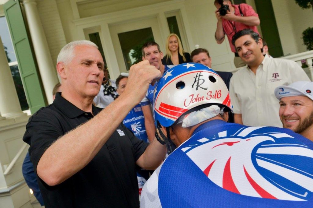 Mike Pence signing cyclist's helmet