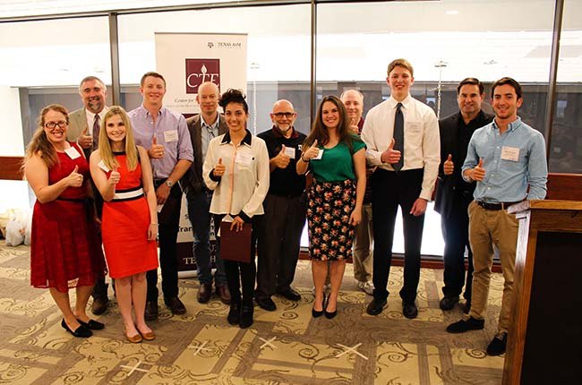 Award recipients pose together with a Gig 'Em