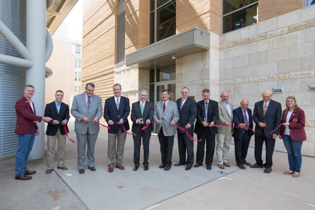 Group of people pose at ribbon cutting ceremony