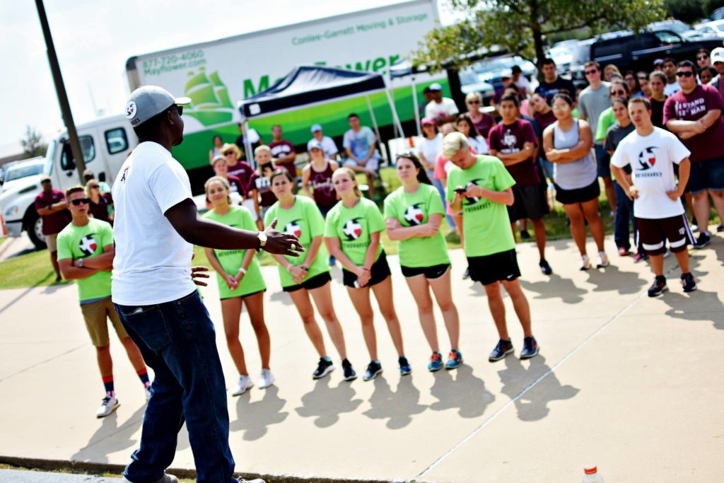 Man giving speech to crowd of volunteers