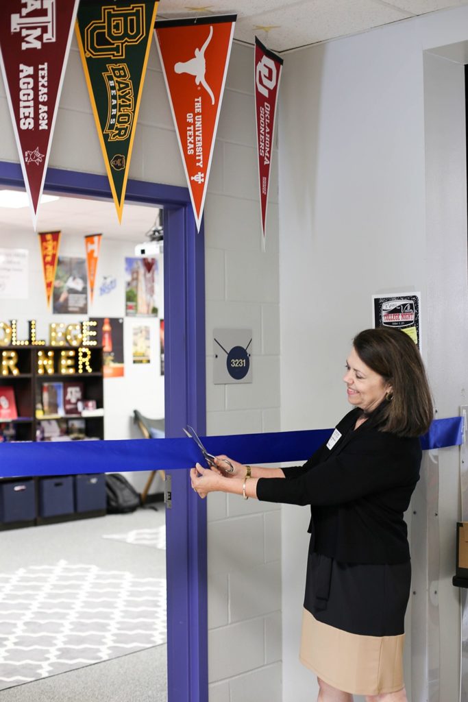 Sue McMillan cuts a ribbon outside of the College Center at Bryan High.