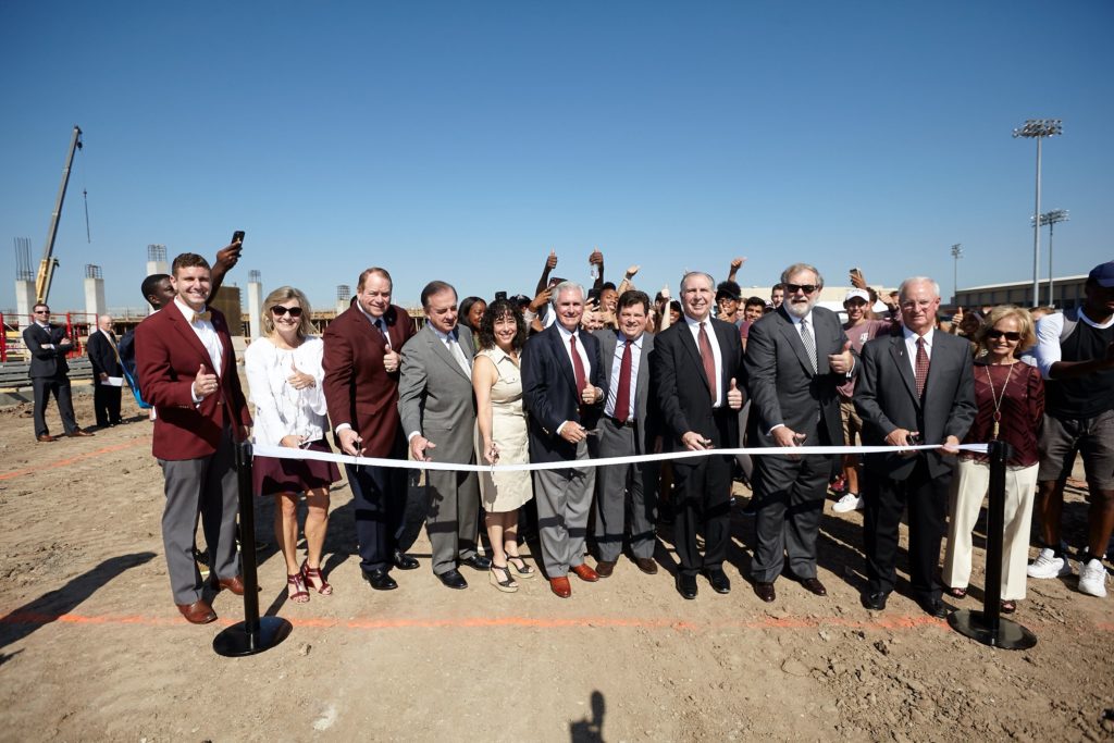 Texas A&M University and system administrators join coaches and donors for a ribbon cutting.