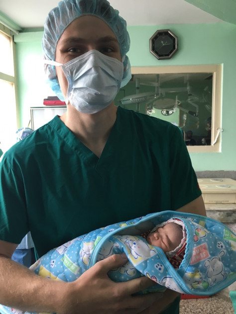 parker bamback holds an infant