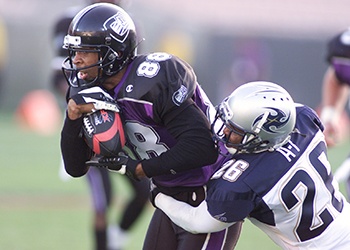 Football player tackling another football player