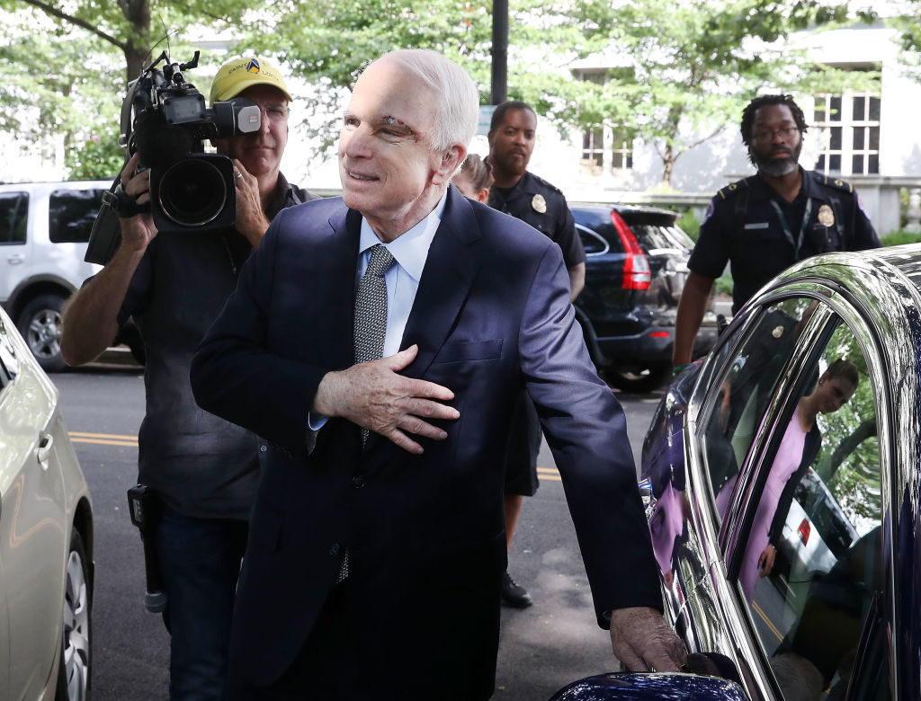 Sen. John McCain (R-AZ) motions to well wishers as he gets into his car at the US Capitol July 25, 2017 in Washington, DC. McCain was recently diagnosed with brain cancer but returned on the day the Senate is holding a key procedural vote on U.S. President Donald Trump's effort to repeal and replace the Affordable Care Act.