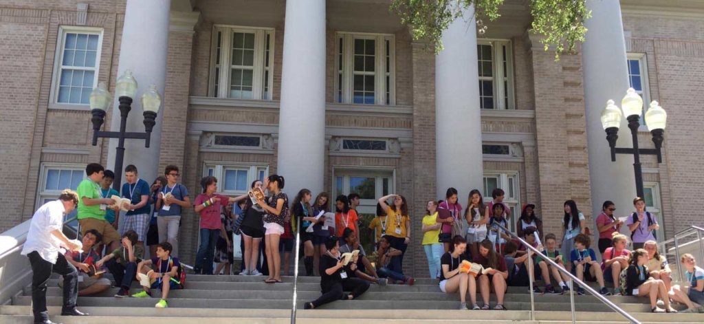 students gather on the steps of a campus building during the P4C summer camp
