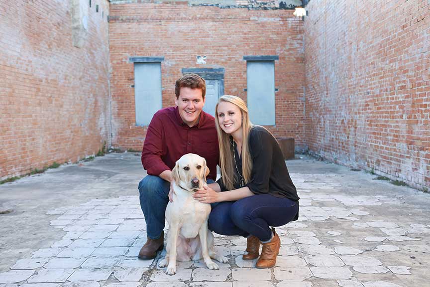 Scott and Hillary Oswald posing with Alika, Hillary's guide dog