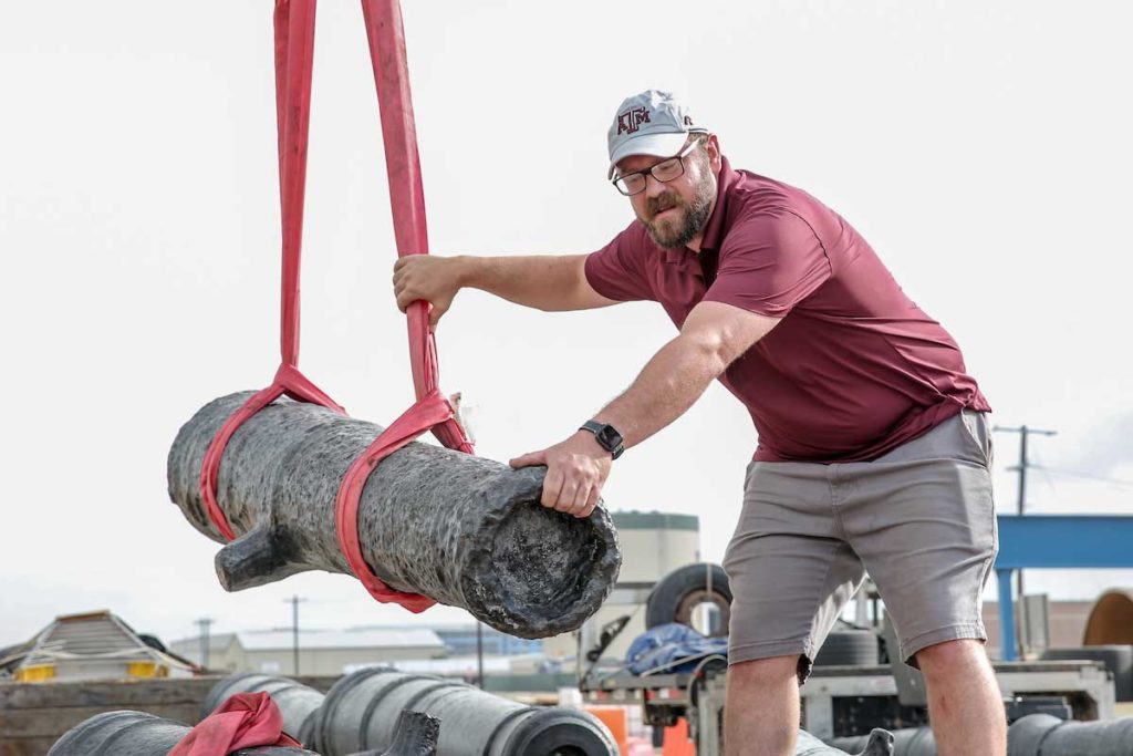 a member of CRL handles a cannon suspended by straps