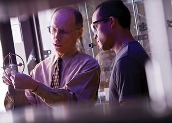Texas A&M Distinguished Professor of Chemistry John A. Gladysz, explaining the reactionary mechanics involved in a molecular gyroscope.