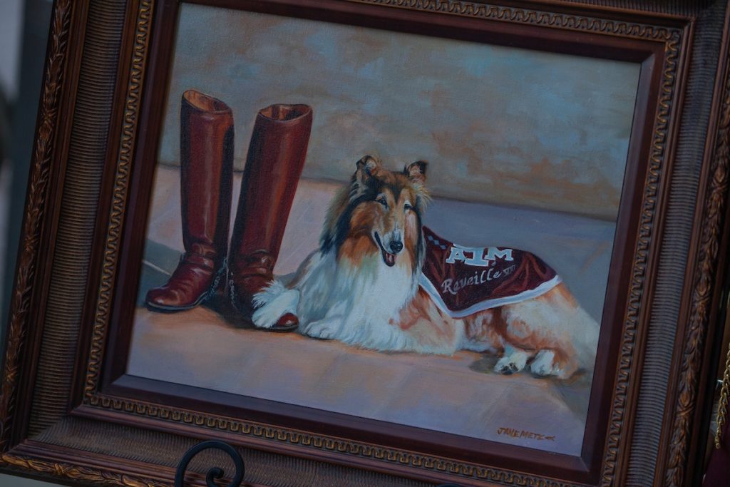 A portrait of Reveille VIII next to corps boots