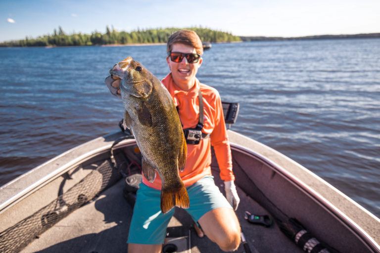Tyler Anderson displays a fish to the camera