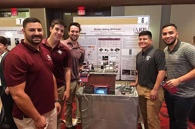 Five students pose with project and poster presentation