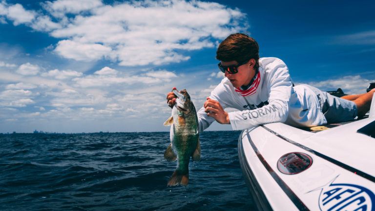 Tyler Anderson handles a fish